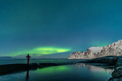 Scenic view of lake against sky at night