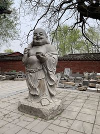 Statue of buddha against trees