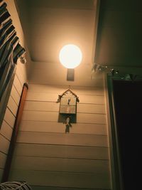 Low angle view of illuminated lamp in building