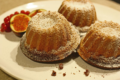 Close-up of cake  and figs in plate on table