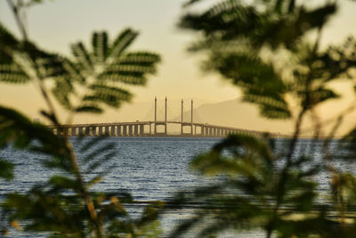 Built structure in water at sunset