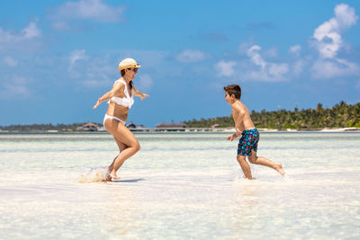 Full length of woman standing at beach