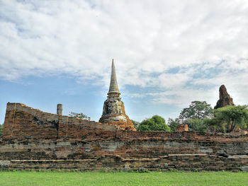 Old temple against cloudy sky