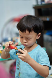 Boy playing with toy at home