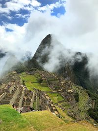 Scenic view of mountains against cloudy sky