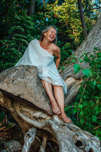 Portrait of smiling young woman in forest