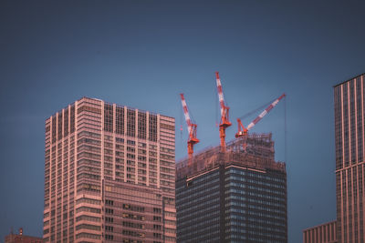 Low angle view of skyscrapers against clear sky