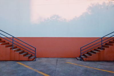 Staircase by building against sky