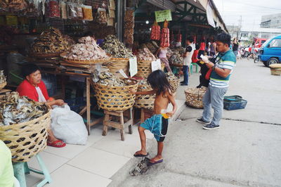 People at market stall in city