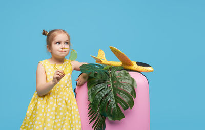 Girl standing against blue background