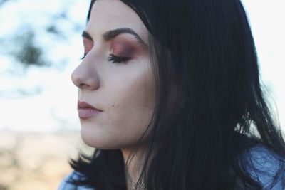 Close-up portrait of a young woman looking away