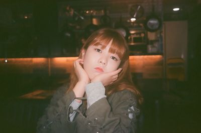 Close-up portrait of girl standing at night