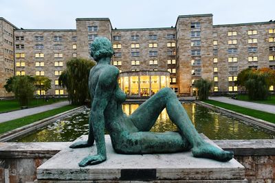 Statue against buildings in city