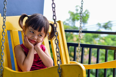 Girl sitting on swing