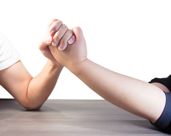 Low section of woman with legs on white background