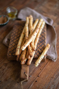 Grissini - italian bread sticks with dried herbs on a wooden background. close up.