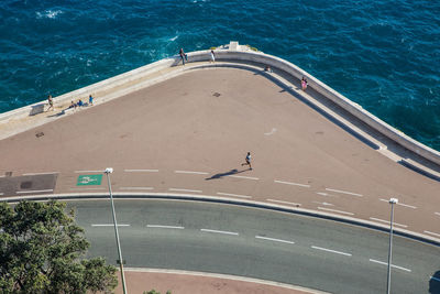 High angle view of people on road by sea