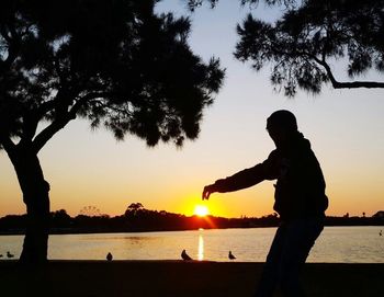 Silhouette of people at sunset