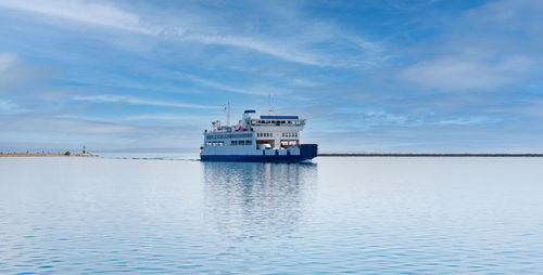 Ship sailing on sea against sky