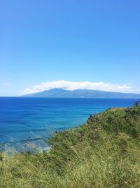 Scenic view of sea against blue sky