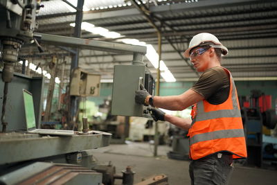 Portrait of male worker standing in the heavy industry manufacturing factory.