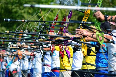 Women aiming with bows during competition