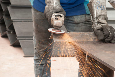 Low section of man working on machine
