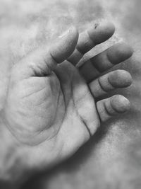 Close-up of father holding baby hand