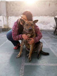 Woman with dog sitting outdoors