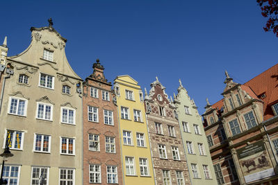 Low angle view of buildings against blue sky