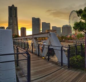 Modern buildings against sky during sunset in city