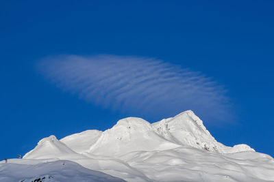 Scenic view of snow against blue sky