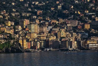 High angle view of buildings by sea