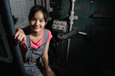 Portrait of young woman standing in factory