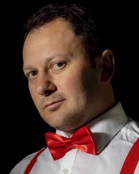 Close-up portrait of man against black background