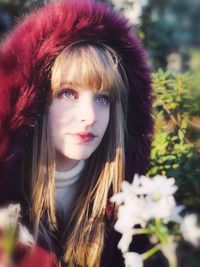 Beautiful young woman in fur coat looking away