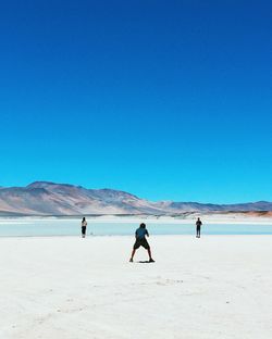 Tourists walking on beach