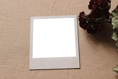 High angle view of photo mockup on table