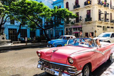 Cars on street by buildings in city