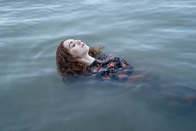 Young woman swimming in lake