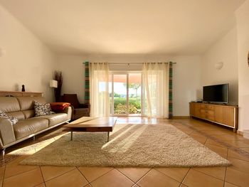 Large living room lit with natural light from glass doors