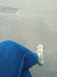 Low section of woman standing on road