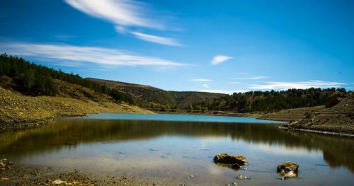 Scenic view of lake against sky at night