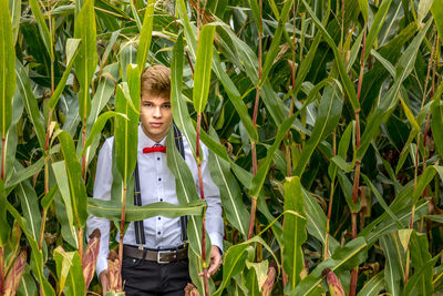 Portrait of young man standing in farm