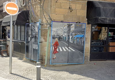 Rear view of people walking on street in city