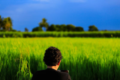 Rear view of man on field