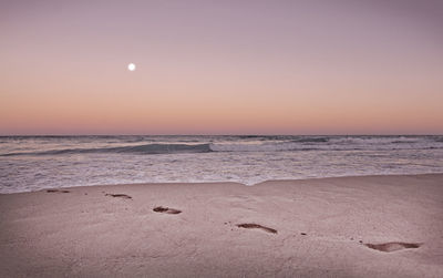 Scenic view of sea against clear sky during sunset