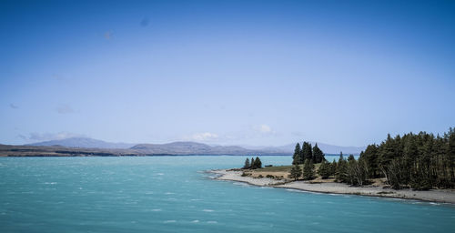 Scenic view of sea against clear blue sky