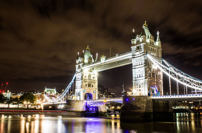 Low angle view of illuminated bridge at night