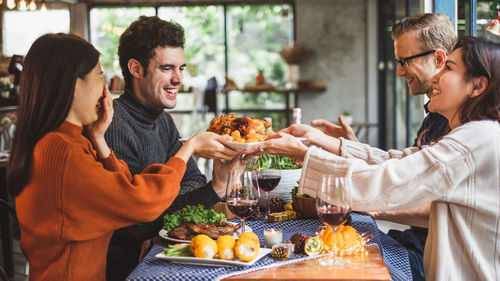 Young man and woman having food in restaurant